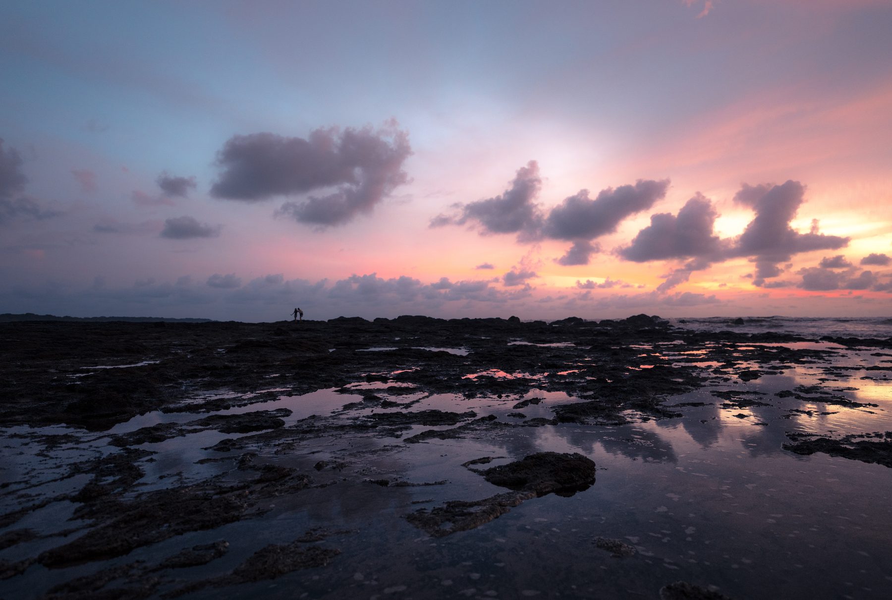 Tide pools reflecting the last light of sunset